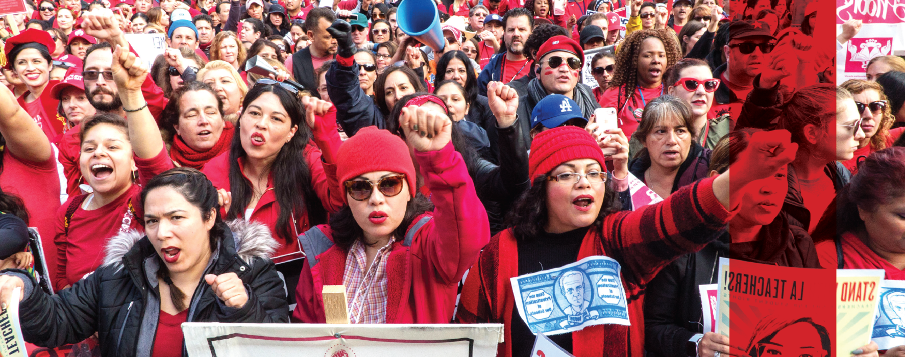 A sea of educators wearing red chants together and hold their firsts in the air, holding signs saying Stand with LA Teachers